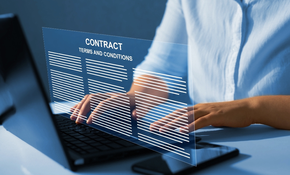 iStock image of person on computer writing contract